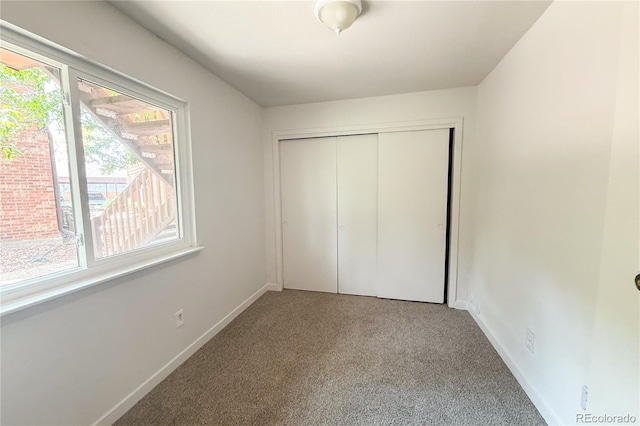 2261 S Buckley Rd Unit 102, Aurora, CO 80013 - unfurnished bedroom with carpet flooring, baseboards, and a closet