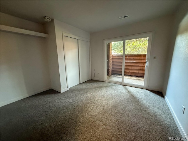 2261 S Buckley Rd Unit 102, Aurora, CO 80013 - unfurnished bedroom featuring access to exterior, carpet, a closet, and baseboards