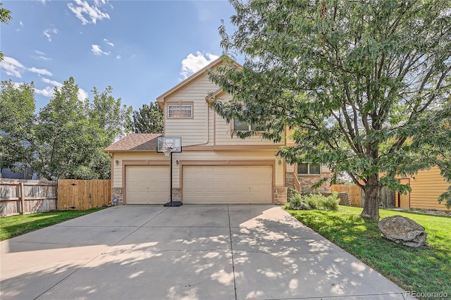 view of front of property featuring a garage and a front lawn