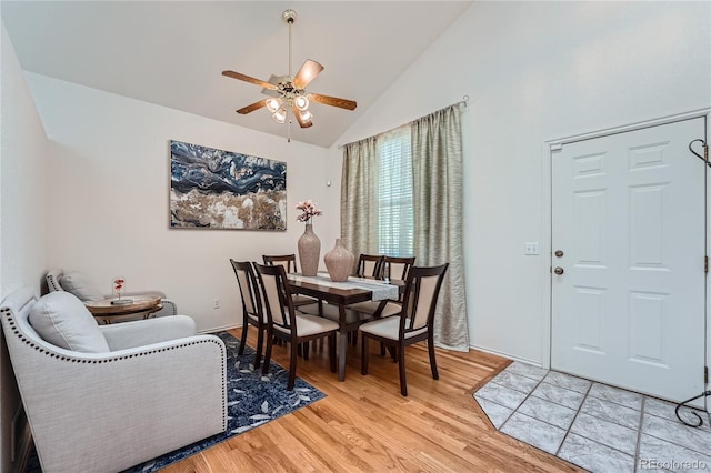 dining space featuring high vaulted ceiling, light hardwood / wood-style flooring, and ceiling fan