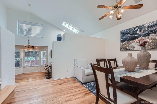 18872 E Prentice Pl, Centennial, CO 80015 - dining space with light wood-type flooring, high vaulted ceiling, a chandelier, and a ceiling fan