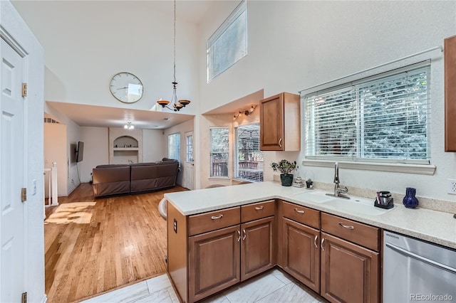 18872 E Prentice Pl, Centennial, CO 80015 - kitchen with stainless steel dishwasher, a sink, a high ceiling, light countertops, and open floor plan