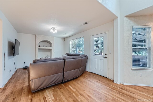 18872 E Prentice Pl, Centennial, CO 80015 - living room featuring light wood-type flooring, built in shelves, and baseboards