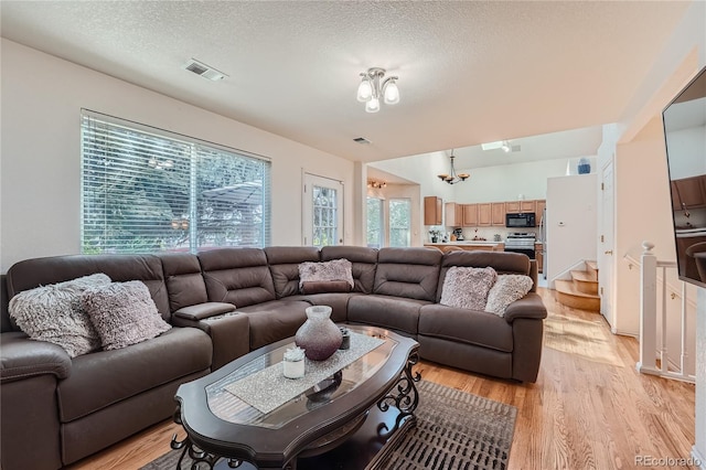 18872 E Prentice Pl, Centennial, CO 80015 - living area with plenty of natural light, light wood-type flooring, and a textured ceiling