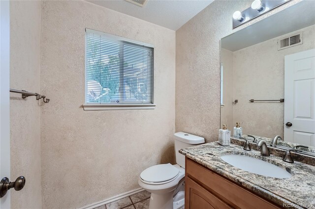 18872 E Prentice Pl, Centennial, CO 80015 - bathroom with a textured wall, toilet, tile patterned flooring, and vanity