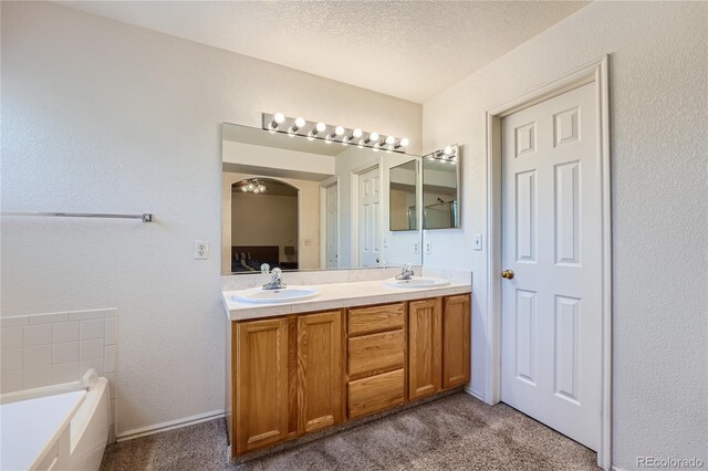 18872 E Prentice Pl, Centennial, CO 80015 - full bathroom with double vanity, a garden tub, a textured ceiling, and a textured wall