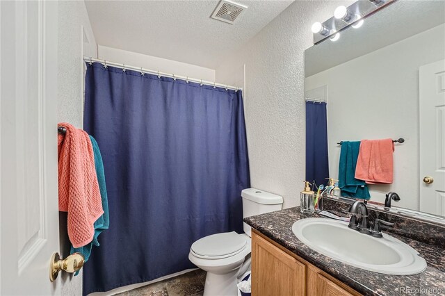 18872 E Prentice Pl, Centennial, CO 80015 - bathroom featuring a textured wall, toilet, vanity, and a textured ceiling