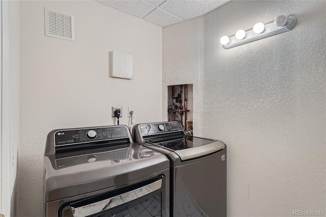 18872 E Prentice Pl, Centennial, CO 80015 - clothes washing area featuring washing machine and dryer and a textured wall