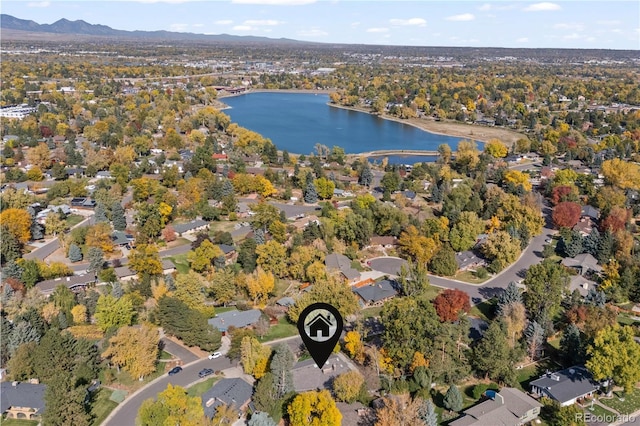 birds eye view of property with a water and mountain view