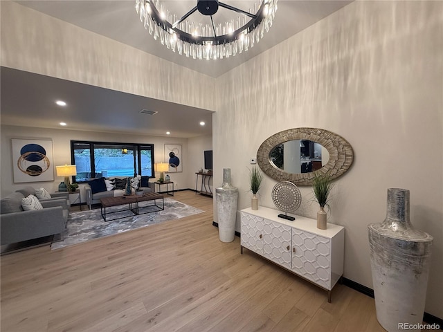 living room with an inviting chandelier and hardwood / wood-style floors