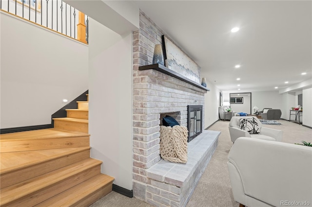 carpeted living room featuring a fireplace