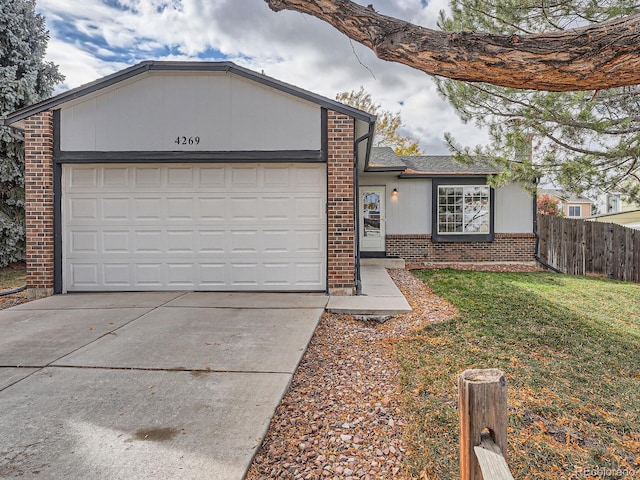 ranch-style home featuring a garage and a front lawn