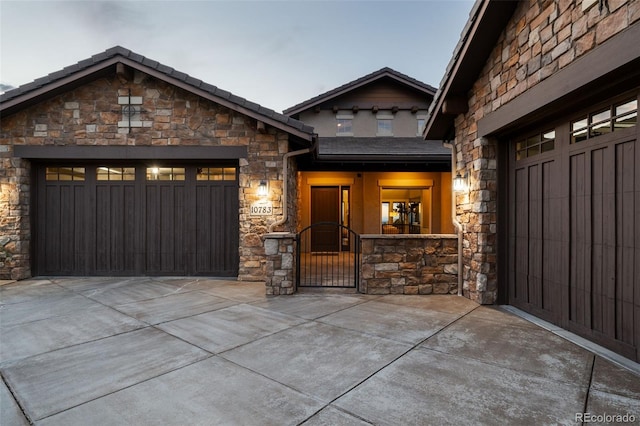 view of front facade with a garage, a gate, and concrete driveway