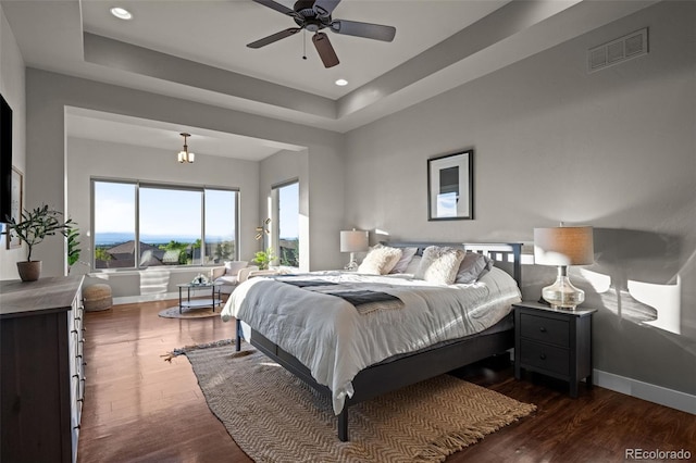 bedroom with dark wood-style floors, baseboards, visible vents, and recessed lighting