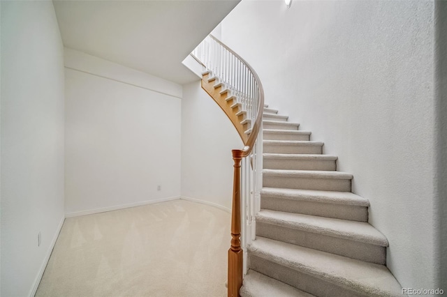 stairway with carpet and baseboards