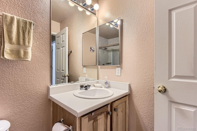 12835 Mayfair Way Unit C, Englewood, CO 80112 - full bath with a textured wall, vanity, and a shower with shower door