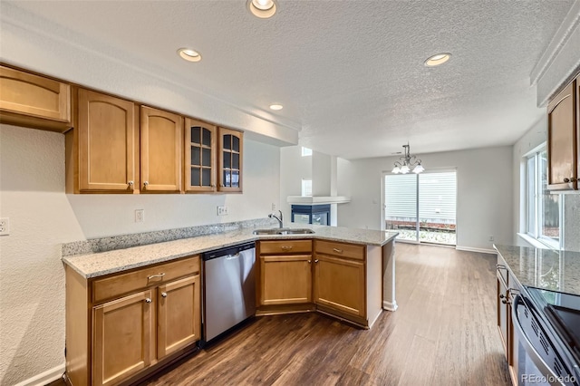 20000 E Mitchell Pl Unit 35, Denver, CO 80249 - kitchen featuring appliances with stainless steel finishes, a sink, a peninsula, dark wood finished floors, and a textured ceiling