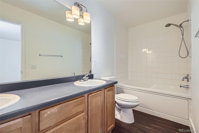 20000 E Mitchell Pl Unit 35, Denver, CO 80249 - bathroom featuring double vanity, toilet, wood finished floors, and tub / shower combination
