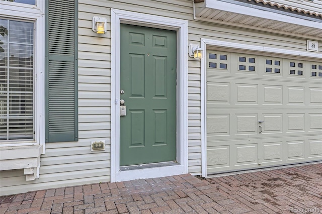 20000 E Mitchell Pl Unit 35, Denver, CO 80249 - doorway to property with a garage and decorative driveway
