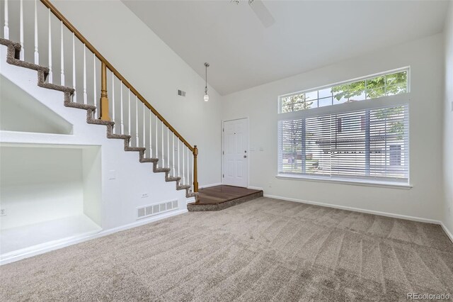 20000 E Mitchell Pl Unit 35, Denver, CO 80249 - entryway with carpet floors, stairway, baseboards, high vaulted ceiling, and a ceiling fan