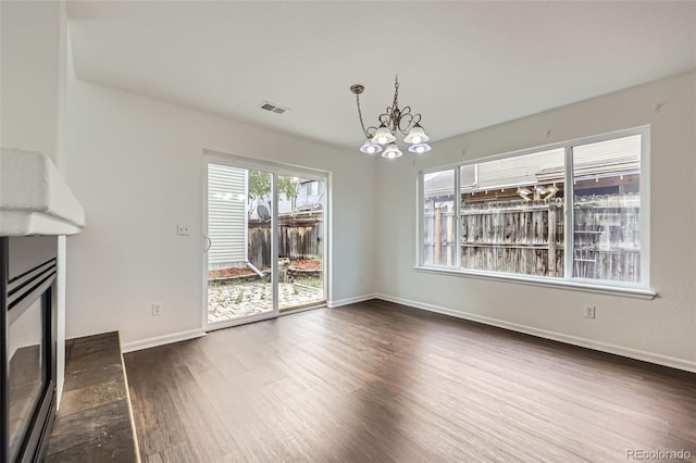 20000 E Mitchell Pl Unit 35, Denver, CO 80249 - unfurnished living room with a chandelier, dark wood-type flooring, and baseboards