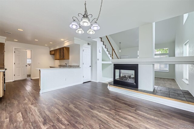 20000 E Mitchell Pl Unit 35, Denver, CO 80249 - unfurnished living room featuring recessed lighting, dark wood-style floors, baseboards, a chandelier, and a multi sided fireplace