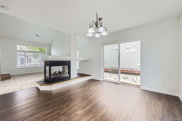 20000 E Mitchell Pl Unit 35, Denver, CO 80249 - unfurnished living room featuring wood finished floors, baseboards, a multi sided fireplace, and vaulted ceiling