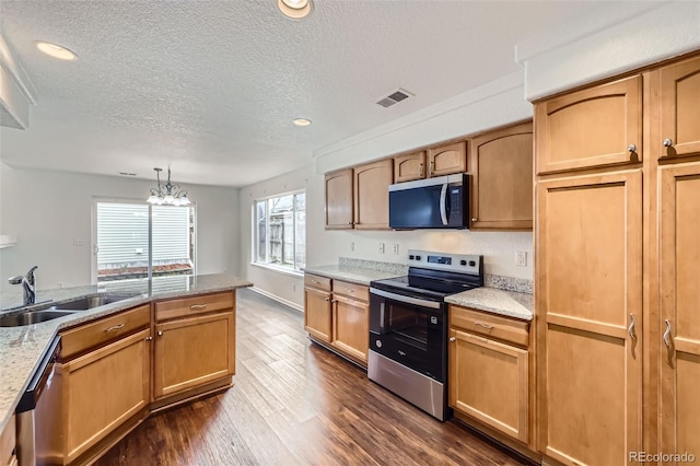 20000 E Mitchell Pl Unit 35, Denver, CO 80249 - kitchen featuring appliances with stainless steel finishes, a textured ceiling, dark wood-type flooring, a chandelier, and a sink