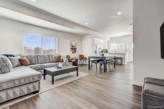 living room with recessed lighting, wood finished floors, and baseboards