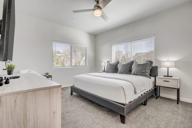 bedroom featuring a ceiling fan, baseboards, and light carpet