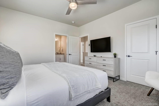 bedroom featuring ceiling fan, ensuite bath, and light carpet