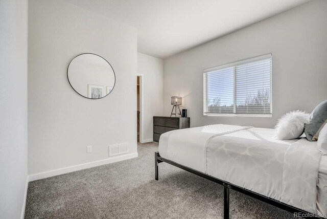 carpeted bedroom featuring visible vents and baseboards