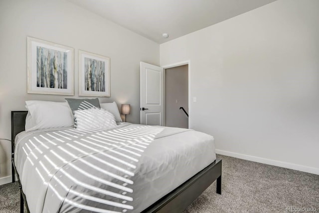 carpeted bedroom featuring baseboards