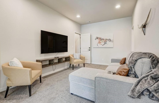 living room featuring recessed lighting, baseboards, and light colored carpet