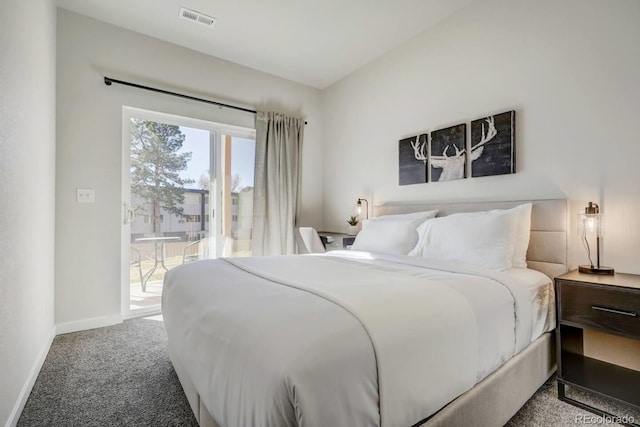 carpeted bedroom with visible vents, baseboards, and access to exterior