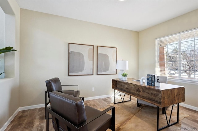 office space with wood-type flooring