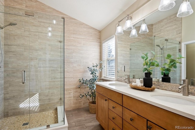 bathroom featuring lofted ceiling, a shower with door, vanity, and hardwood / wood-style flooring