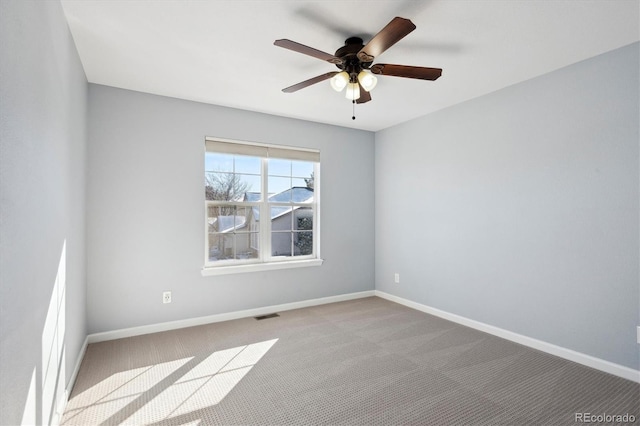 carpeted spare room with ceiling fan