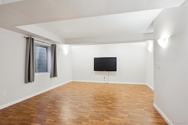 basement with hardwood / wood-style flooring