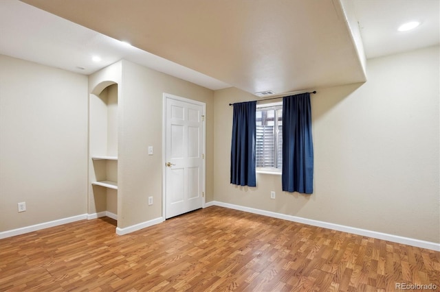 spare room with light wood-type flooring