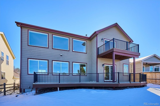 snow covered property featuring a balcony