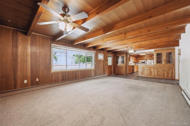 209 S 13th Ave, Brighton, CO 80601 - unfurnished living room featuring wood ceiling with exposed beams, baseboard heating, wood walls, a ceiling fan, and light colored carpet