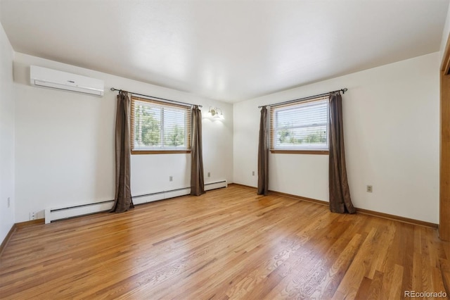 209 S 13th Ave, Brighton, CO 80601 - spare room with an AC wall unit, plenty of natural light, light wood-style floors, and baseboard heating