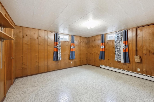 209 S 13th Ave, Brighton, CO 80601 - below grade area featuring plenty of natural light, a baseboard heating unit, and wooden walls