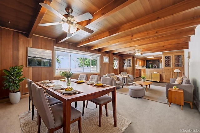 209 S 13th Ave, Brighton, CO 80601 - carpeted dining room featuring a wood ceiling with exposed beams, ceiling fan, and wood walls