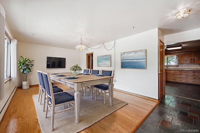 209 S 13th Ave, Brighton, CO 80601 - dining area with baseboard heating and a chandelier