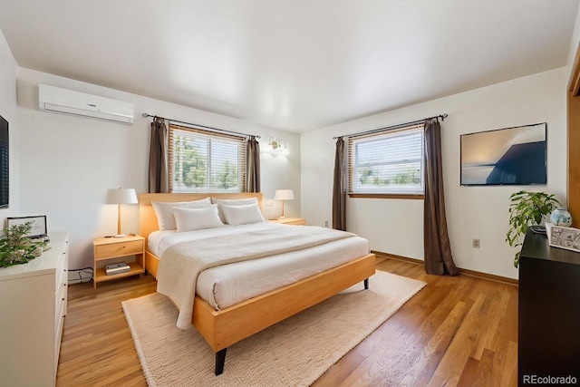 209 S 13th Ave, Brighton, CO 80601 - bedroom with an AC wall unit, multiple windows, and light wood-style floors