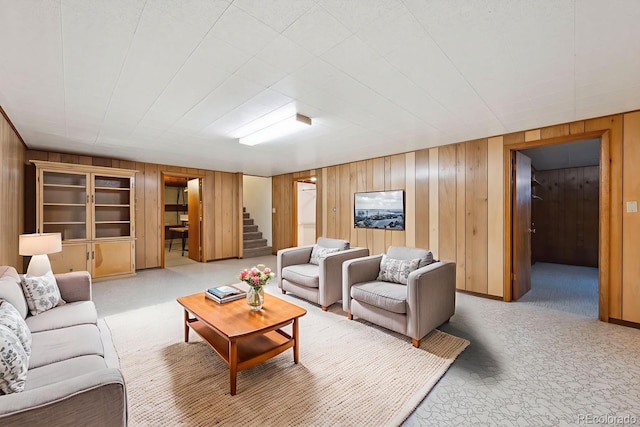 209 S 13th Ave, Brighton, CO 80601 - carpeted living area featuring wood walls, stairs, and built in shelves