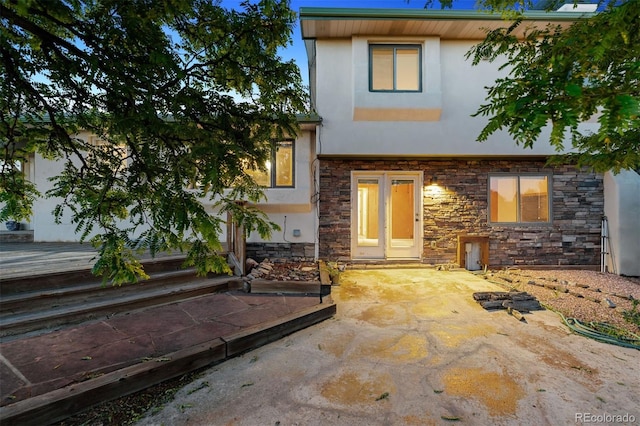 4627 Cathy Ln, Erie, CO 80516 - property entrance with stucco siding, stone siding, and a patio area