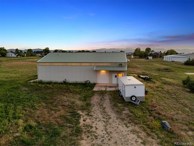 4627 Cathy Ln, Erie, CO 80516 - view of front of home featuring a metal roof, a yard, driveway, and an outdoor structure